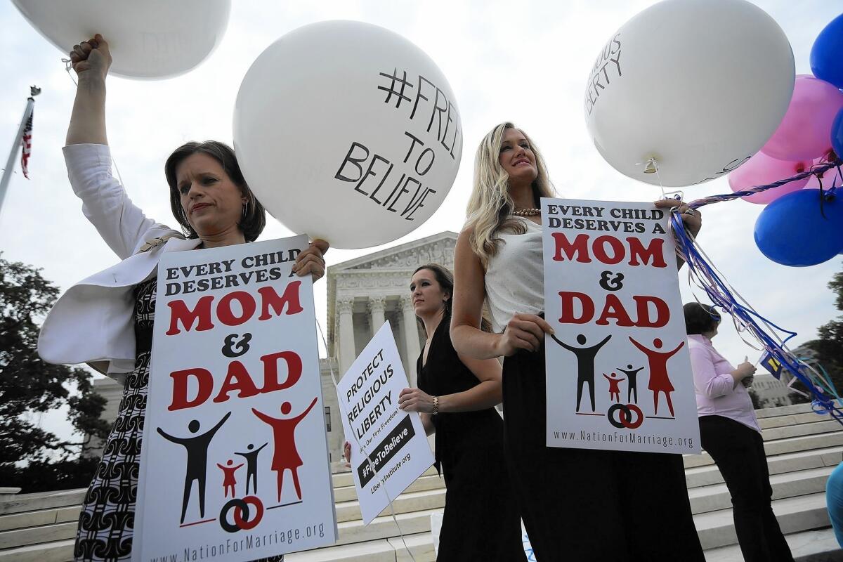 Jennifer Marshall, left, of the Heritage Foundation and Summer Ingram, right, of the Congressional Prayer Caucus Foundation protest same-sex marriage outside the Supreme Court.