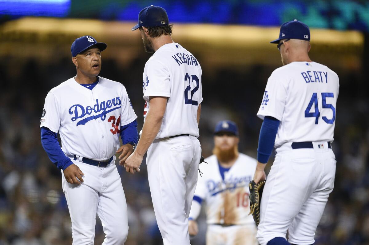 Dodgers manager Dave Roberts, left, relieves starting pitcher Clayton Kershaw during the fifth inning of Friday's game.