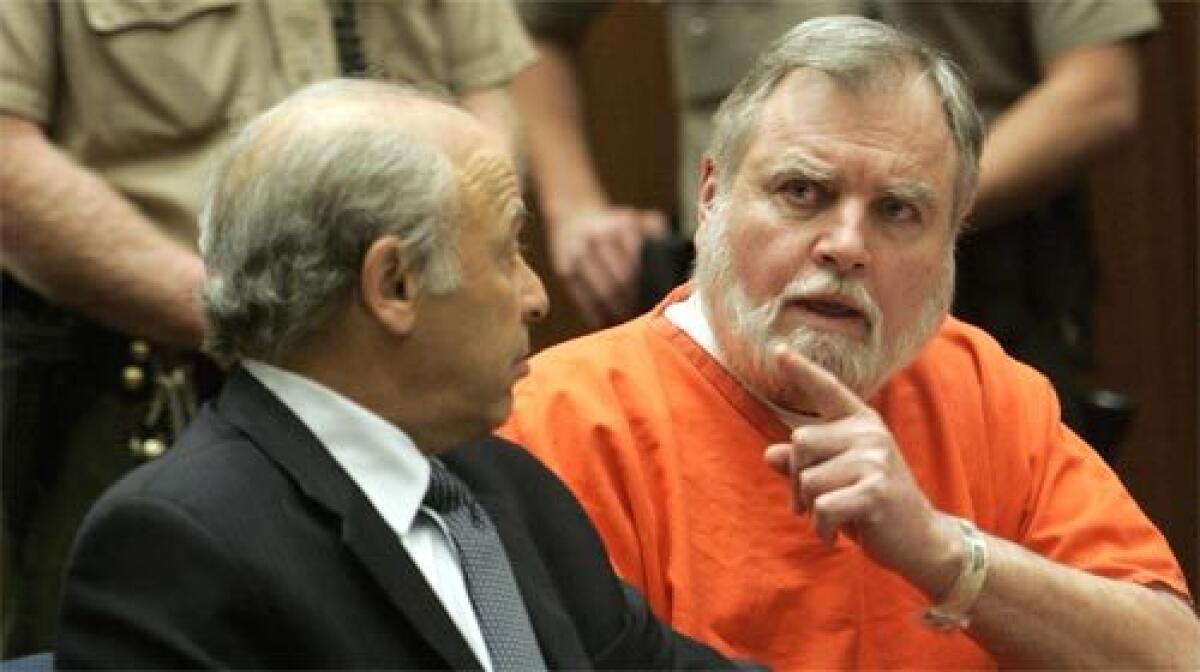 Defrocked priest Michael Baker, right, with his attorney, Leonard Levine, asks for clarification on a question directed to him.