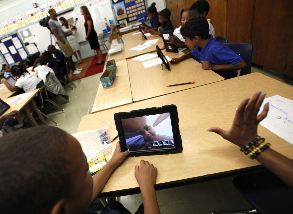 A student takes a picture of himself during a class at Broadacres Elementary School in Carson.