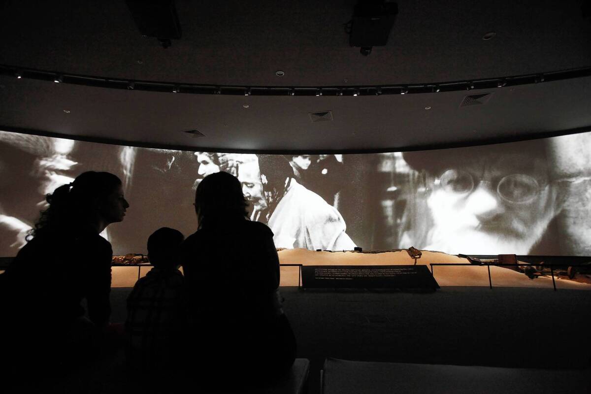 Visitors watch a documentary on the Holocaust in Russia's new museum of Jewish history and culture.