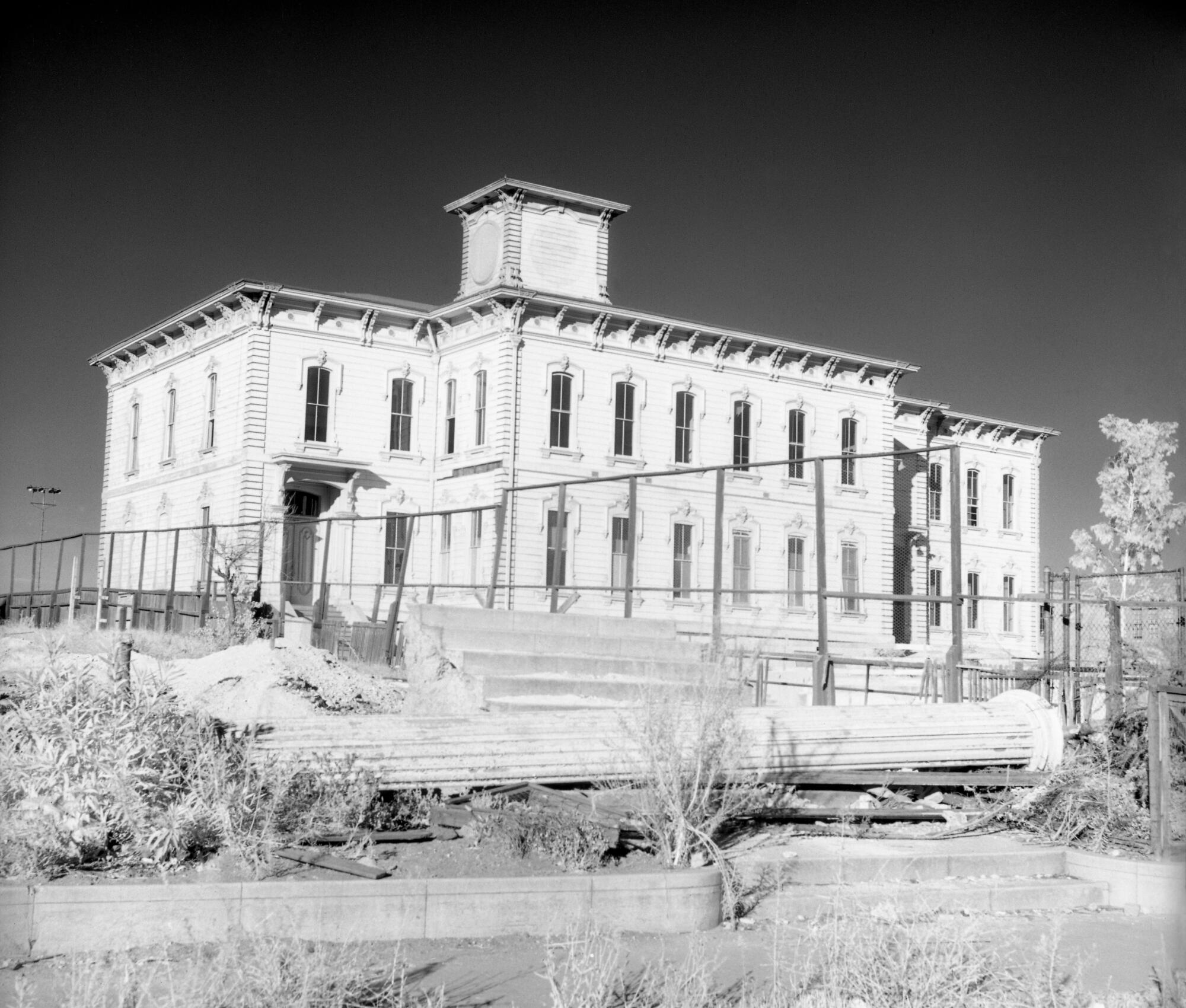 The original Los Angeles High School with a fence around it
