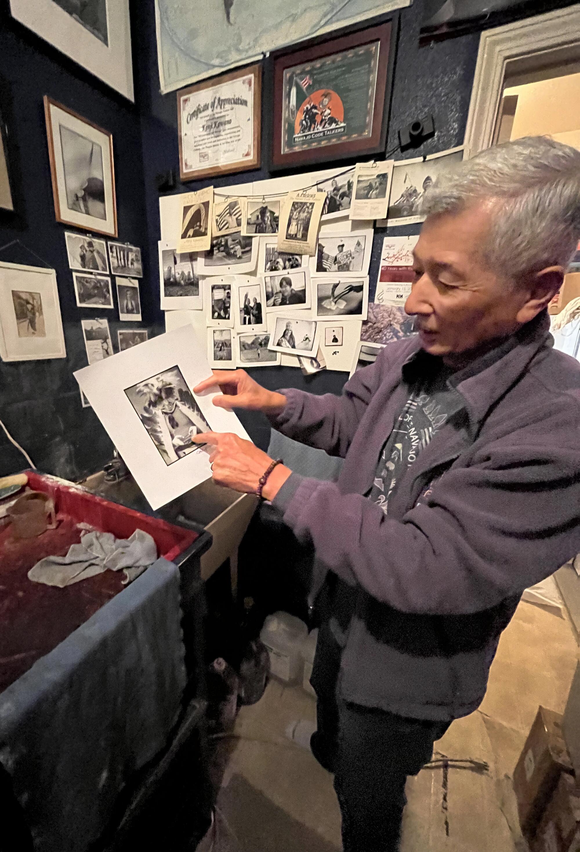 Kenji Kawano holds up a photograph.