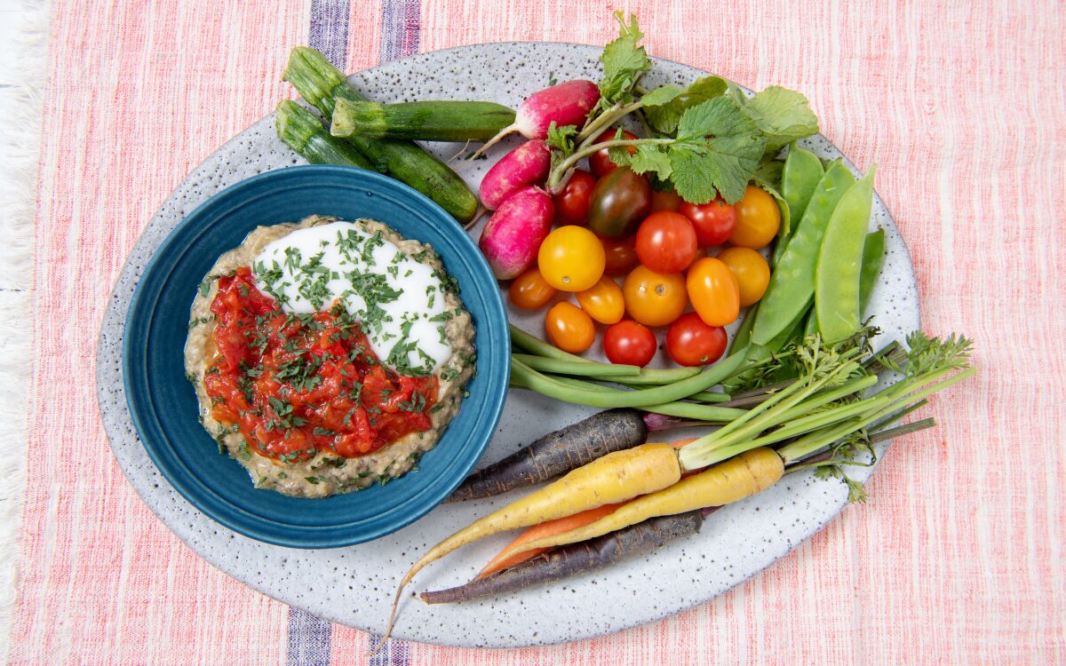 Smoky Eggplant Dip With Ginger and Tomato Chutney with an assortment of colorful crudites.