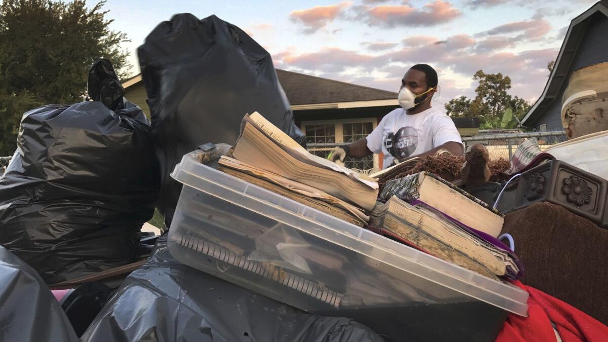 Steven Williams helps clear out his wife's grandmother's home after Hurricane Harvey flooded Port Arthur, Texas.