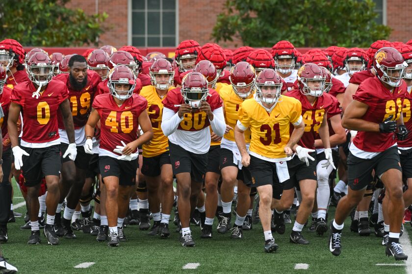 LOS ANGELES, CA - AUG. 5, 2022: USC players head to practice during the first day of fall training camp at USC. (Michael Owen Baker / For The Times)