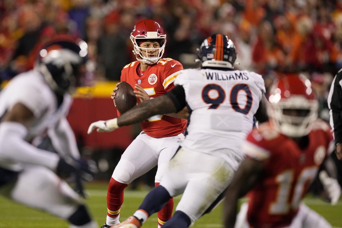 Kansas City Chiefs quarterback Patrick Mahomes looks to pass against the Denver Broncos.