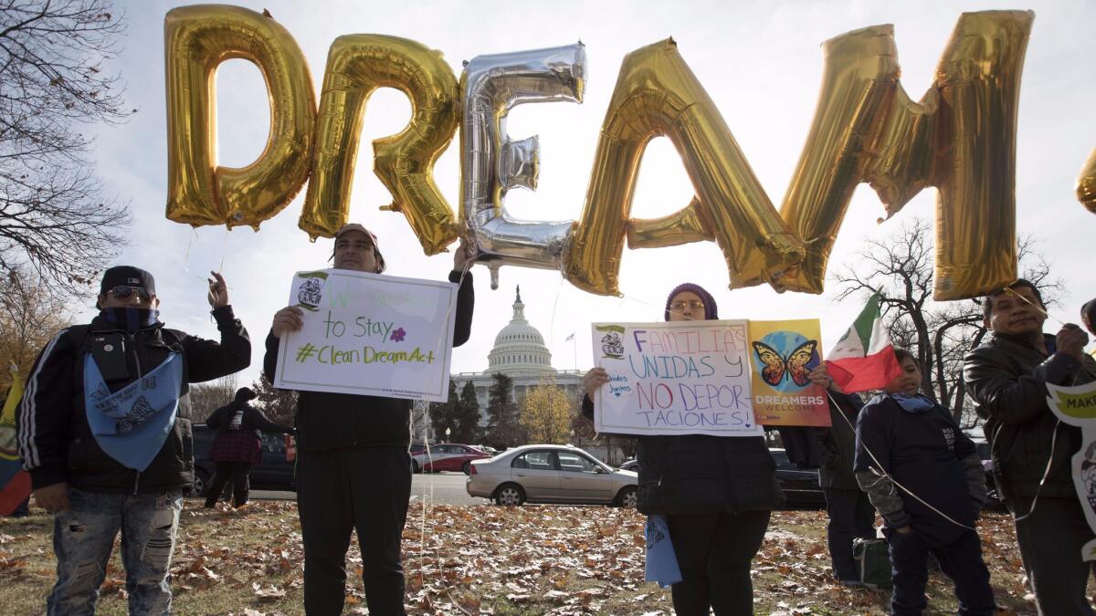 People hold balloons that read 'Dream Act Now', to voice support for the passage of the 'clean' DREAM Act at a rally on Capitol Hill in Washington on Dec. 6.