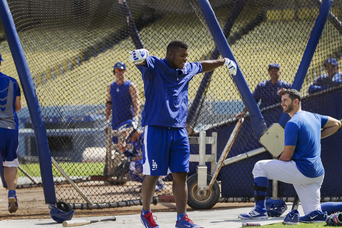 Dodgers outfielder Yasiel Puig with teammates during batting practice at Dodger Stadium on Tuesday.