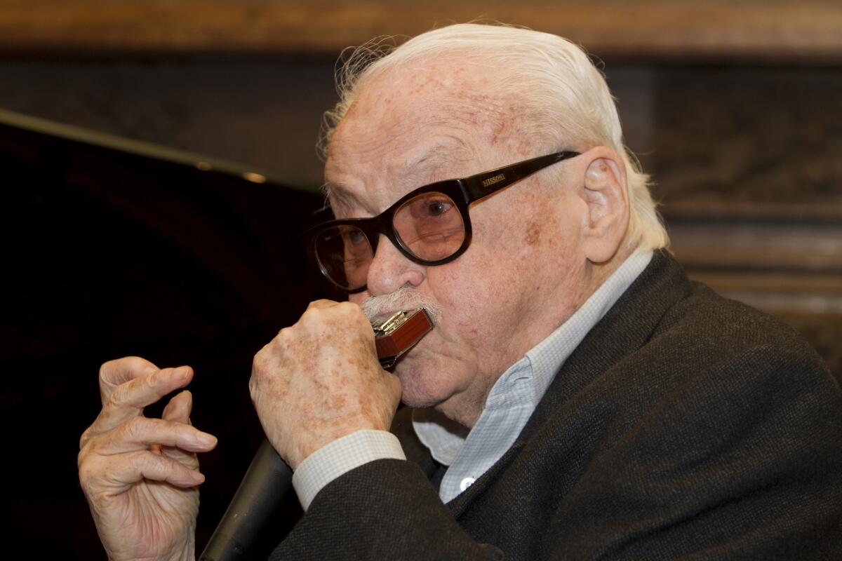 Toots Thielemans plays a harmonica during a celebration of his 90th birthday in La Hulpe, Belgium, on Feb. 29, 2012.