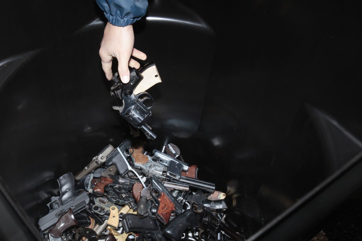 A bin filled with pistols at the buyback.