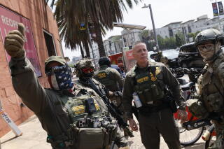 A Border Patrol official marches with federal agents