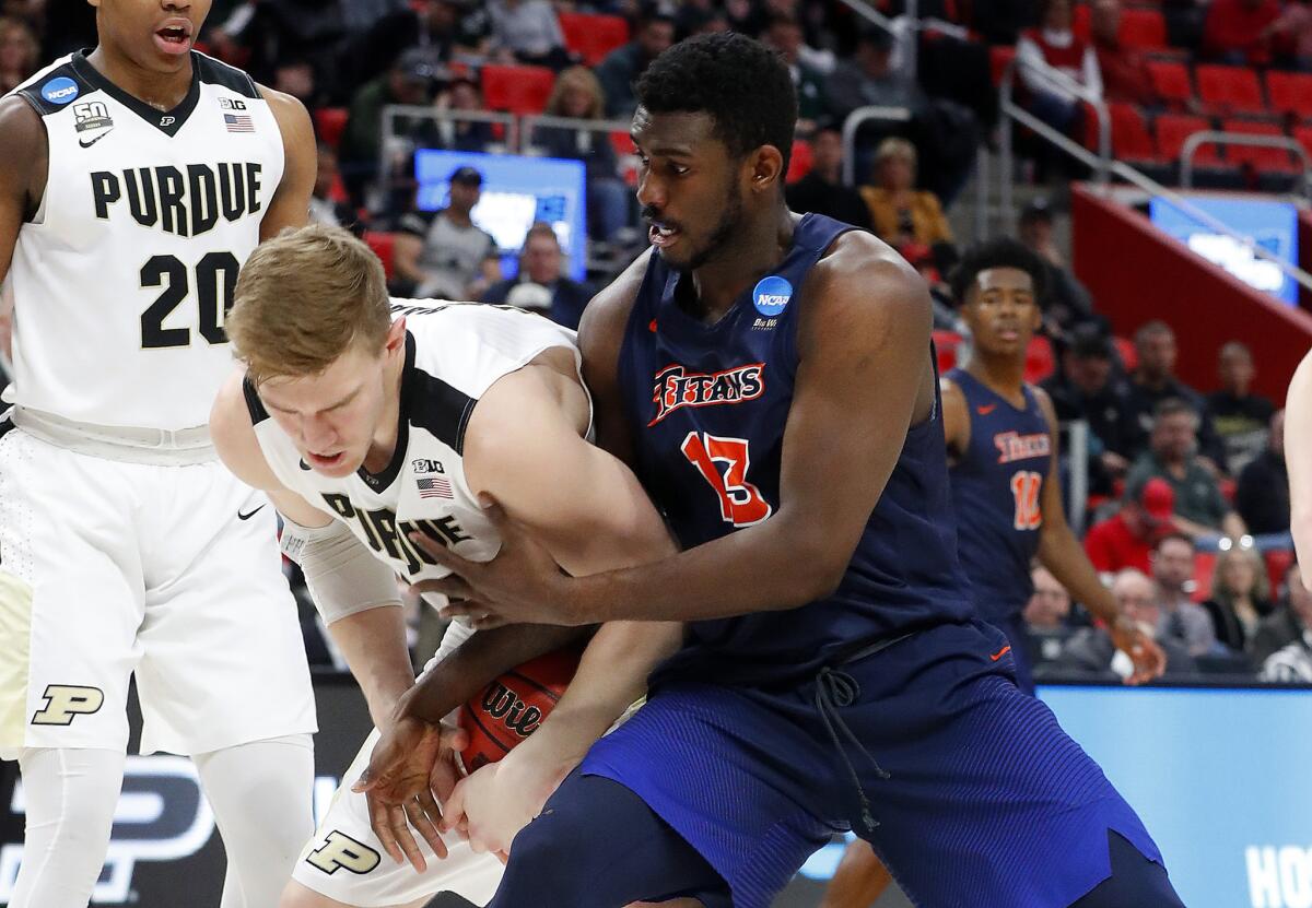 Purdue center Isaac Haas, left, and Cal State Fullerton forward Arkim Robertson battle for the ball.