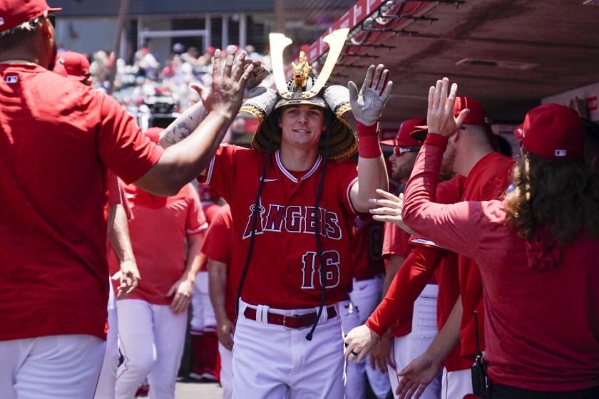 Los Angeles Angels' Mickey Moniak (16) celebrates in the dugout after hitting a home run during the first inning of a baseball game against the Chicago White Sox in Anaheim, Calif., Thursday, June 29, 2023. (AP Photo/Ashley Landis)