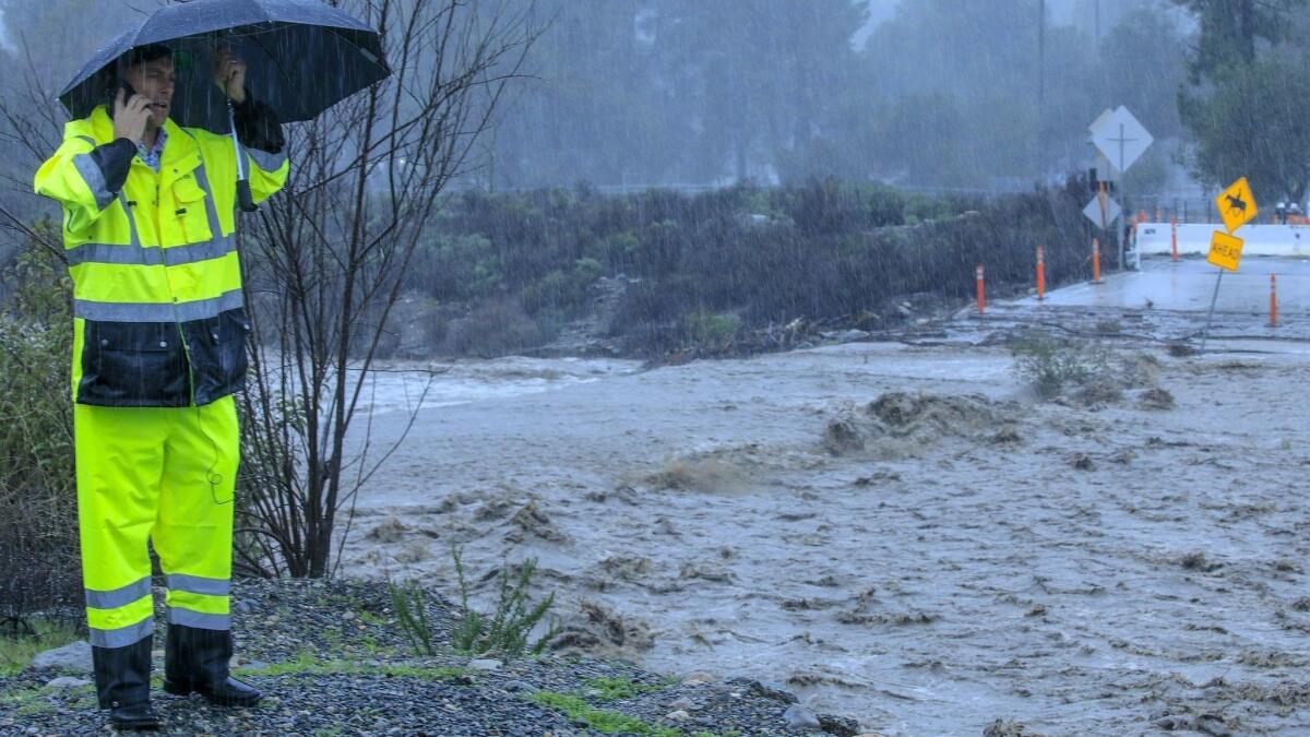 Orange County Public Works' Shannon Widor surveys damage where Trabuco Creek overflowed the Trabuco Canyon Road bridge last week.