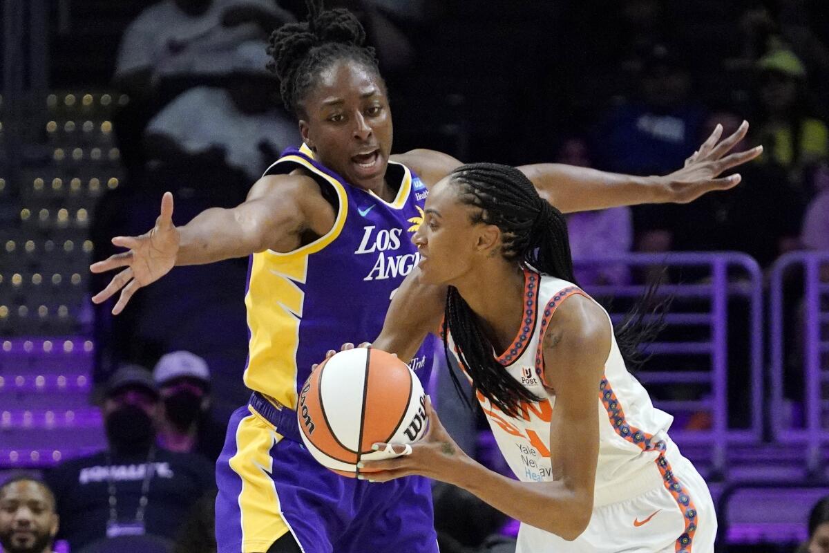 Sparks forward Nneka Ogwumike, top, defends against Connecticut Sun forward DeWanna Bonner during a loss Thursday.