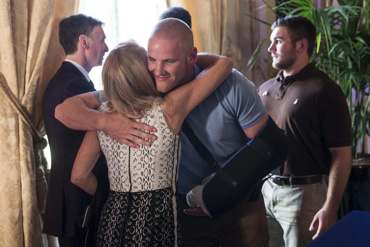 U.S. Ambassador to France Jane Hartley hugs U.S. serviceman Spencer Stone after a press conference at the U.S. embassy in Paris.