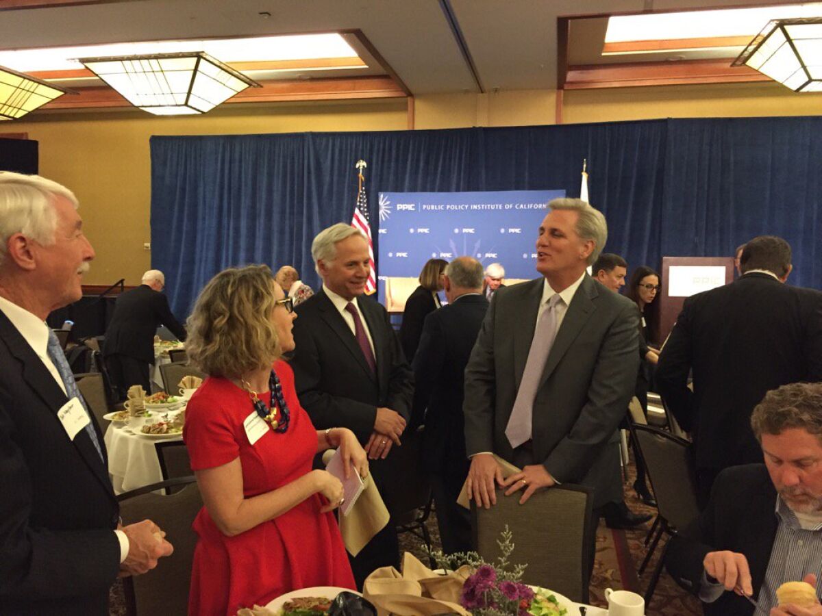 House Majority Leader Kevin McCarthy (R-Bakersfield), standing right, chats with guests at an event hosted by the Public Policy Institute of California.