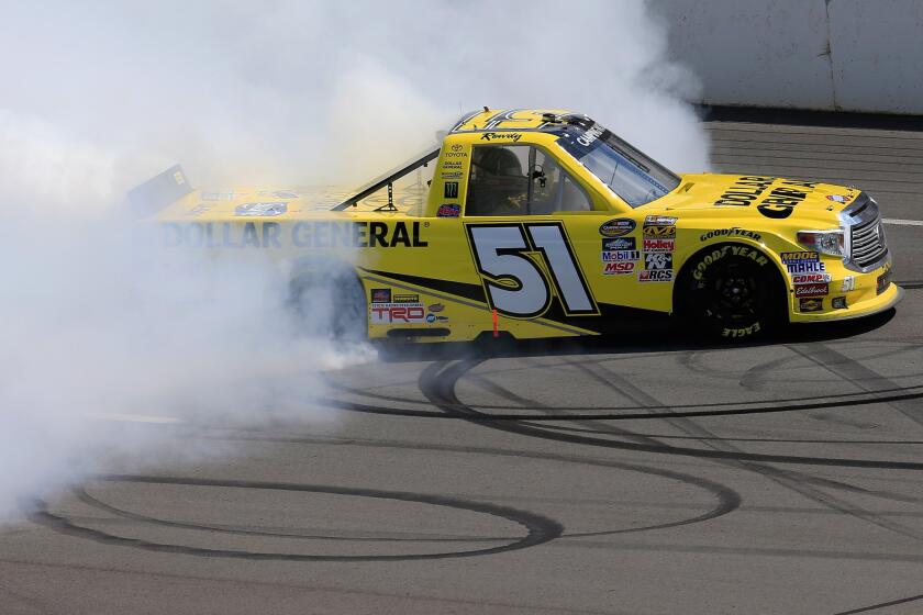 Kyle Busch celebrates with a burnout after winning the NASCAR Camping World Truck Series Pocono Mountains 150 on Saturday at Pocono Raceway.