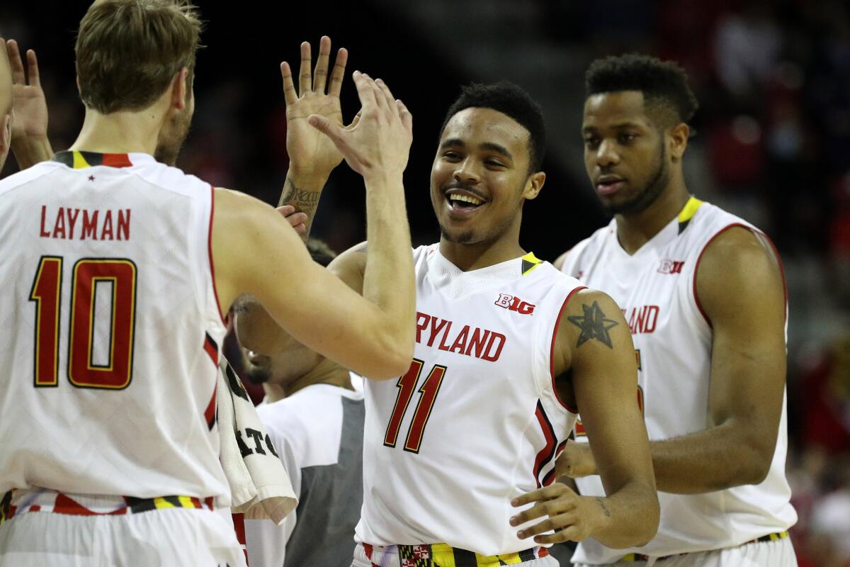 Maryland guard Jared Nickens (11) celebrates with teammate Jake Layman against the Illinois Fighting Illini during the second half.