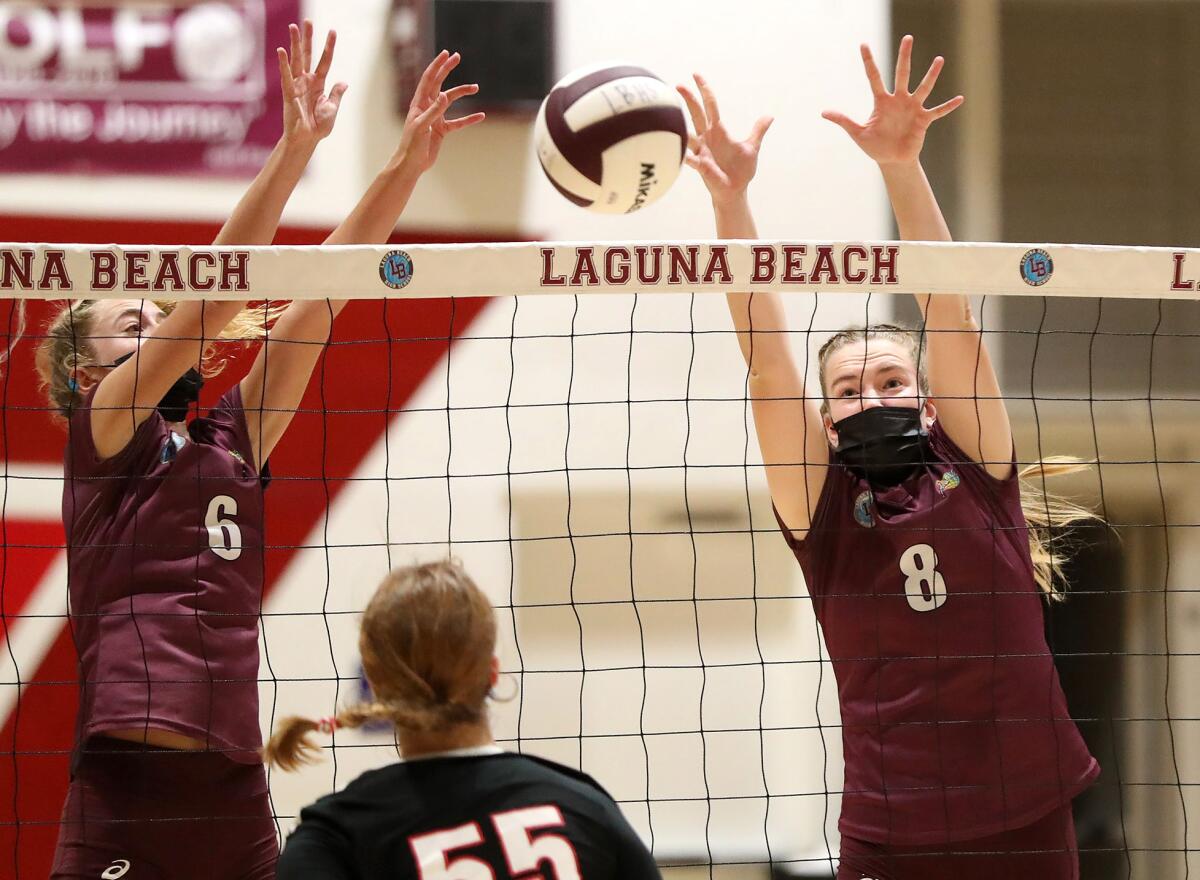 Laguna Beach's Natalia Hagopian (6) and Jacqueline Witteman (8) block against La Canada Flintridge's Peyton DeJardin (55).