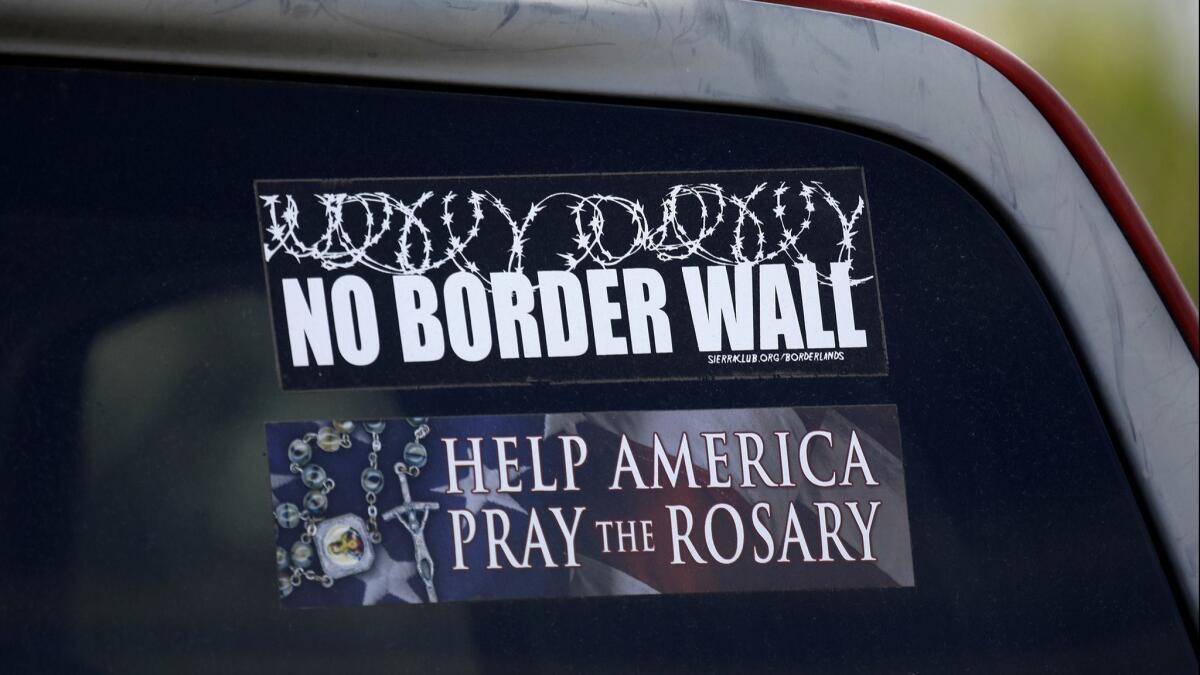 Noel Benavides of Roma, Texas, expresses his feelings about a potential border wall with a bumper sticker on his pickup truck.