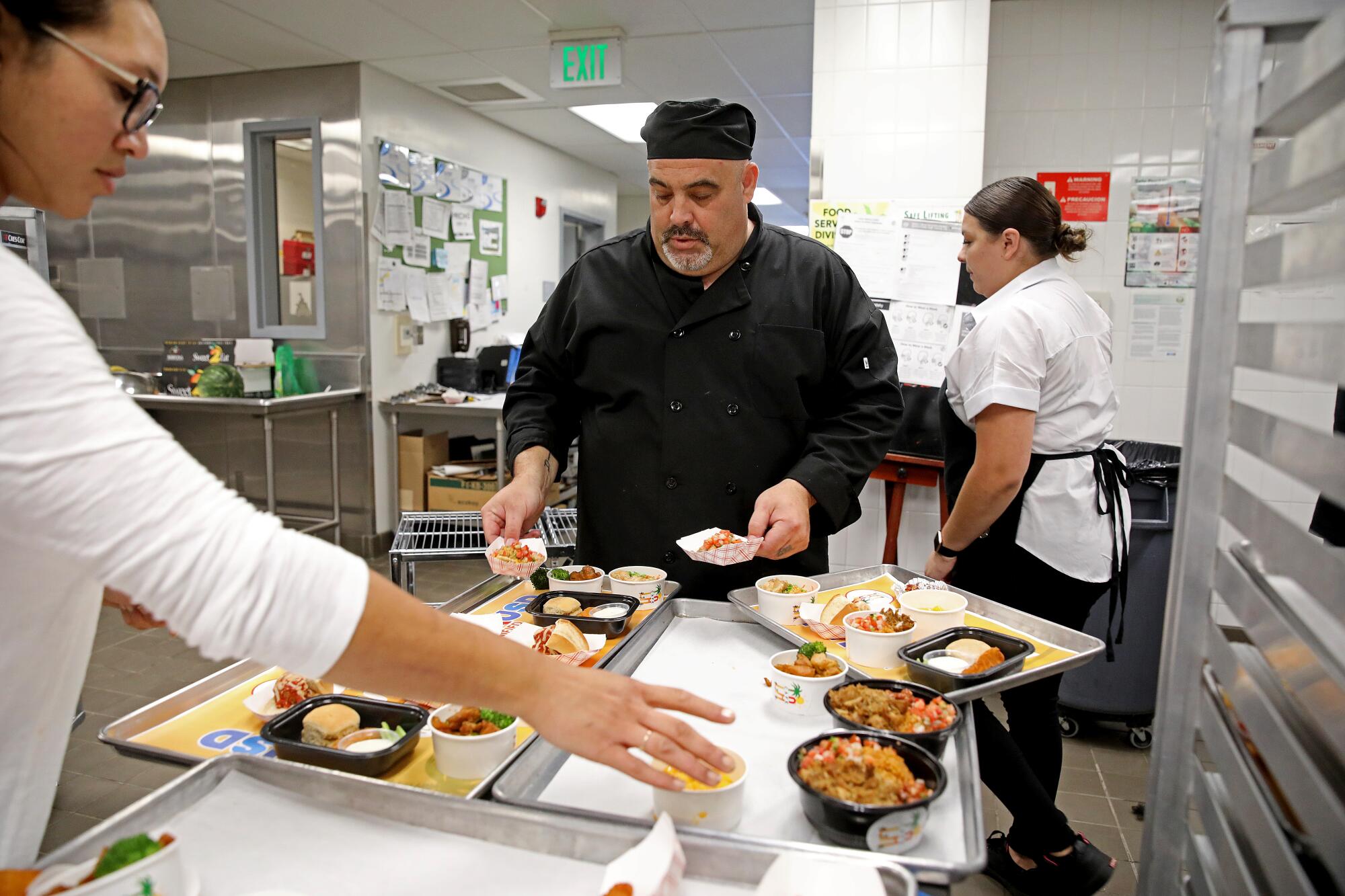 Mario Fiore arranges cafeteria samples on a tray.