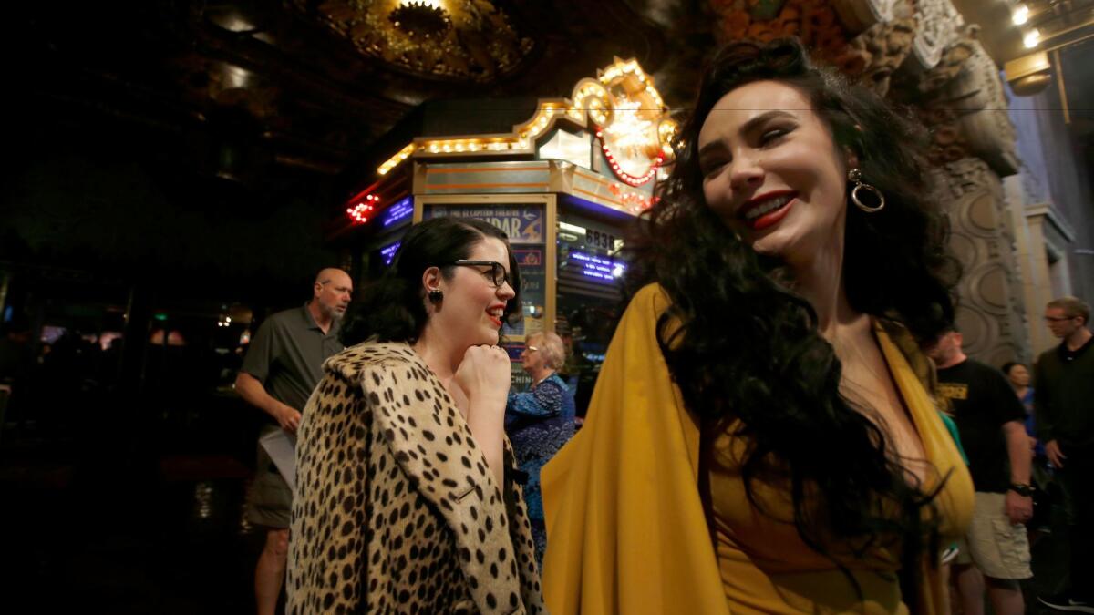 Melissa Firestone, left, of Pasadena and Micheline Pitt, right, of Burbank at Hollywood's El Capitan Theatre for Thursday's first L.A. public screening of "Beauty and the Beast."
