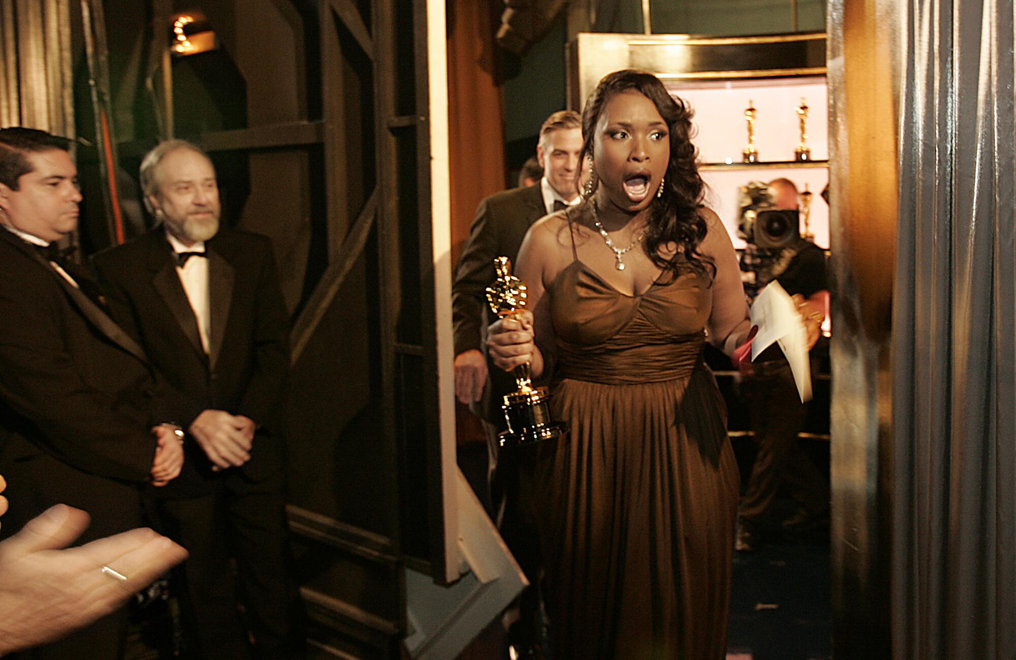 2007: Jennifer Hudson is open-mouthed in excitement exiting the stage with her supporting actress Oscar
