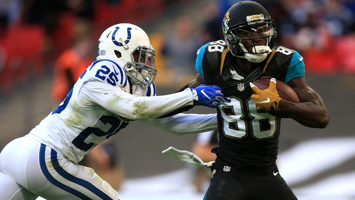 Jaguars receiver Allen Hurns tries to fend off a tackle attempt by Colts defensive back Patrick Robinson during their game Sunday.