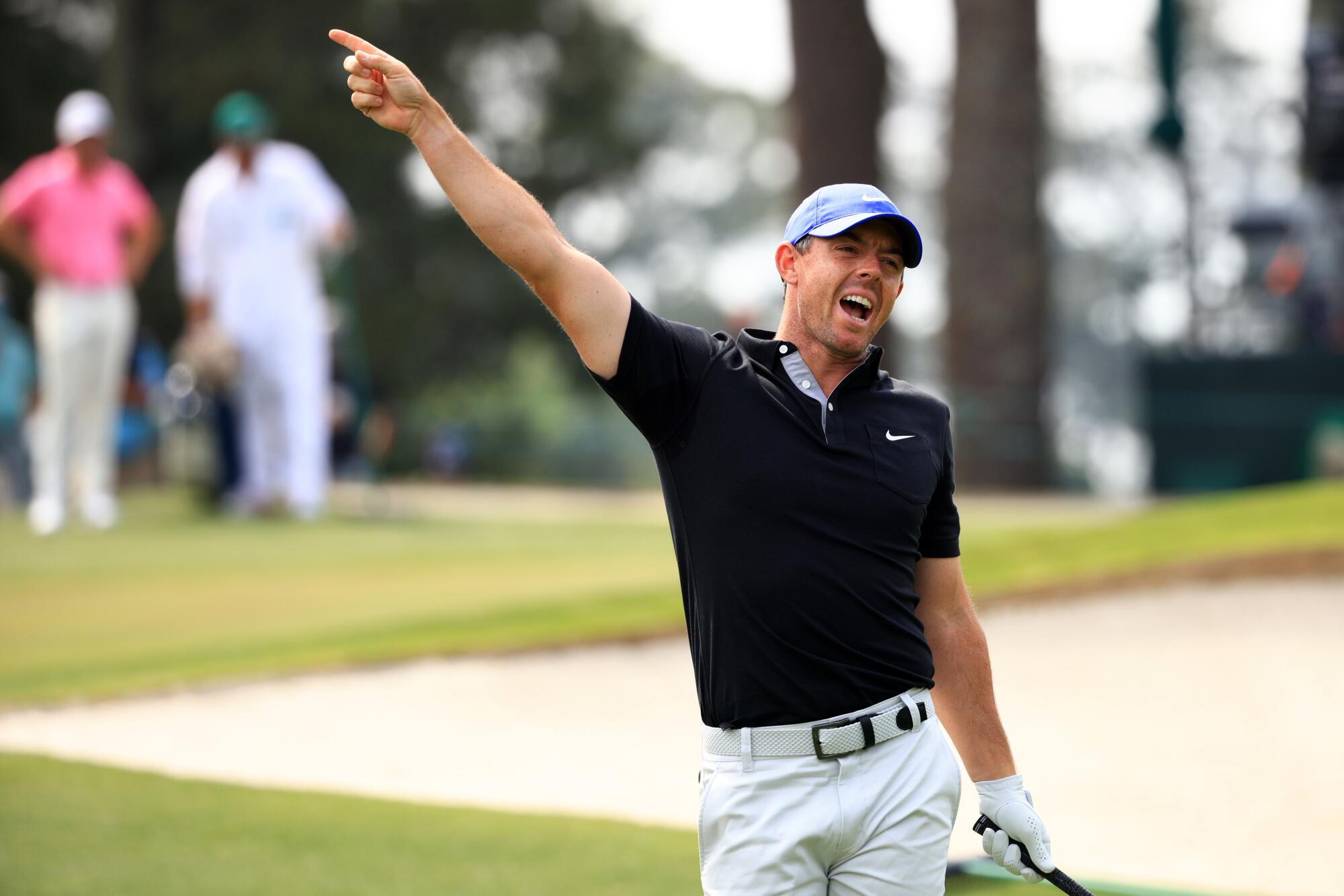 Rory McIlroy of Northern Ireland reacts to his tee shot on the third hole 