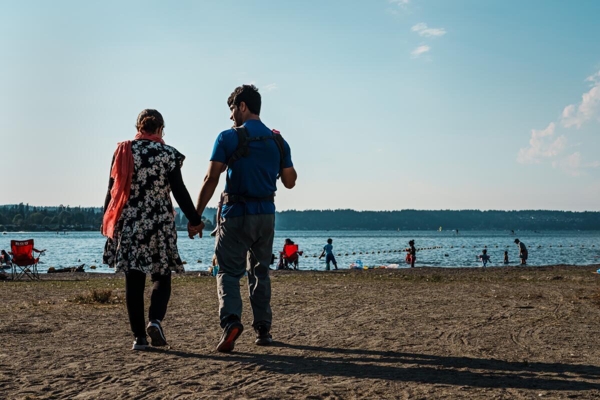 A couple holding hands on the beach