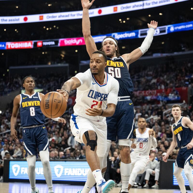Clippers guard Norman Powell passes in front of Denver Nuggets forward Aaron Gordon in the second half.