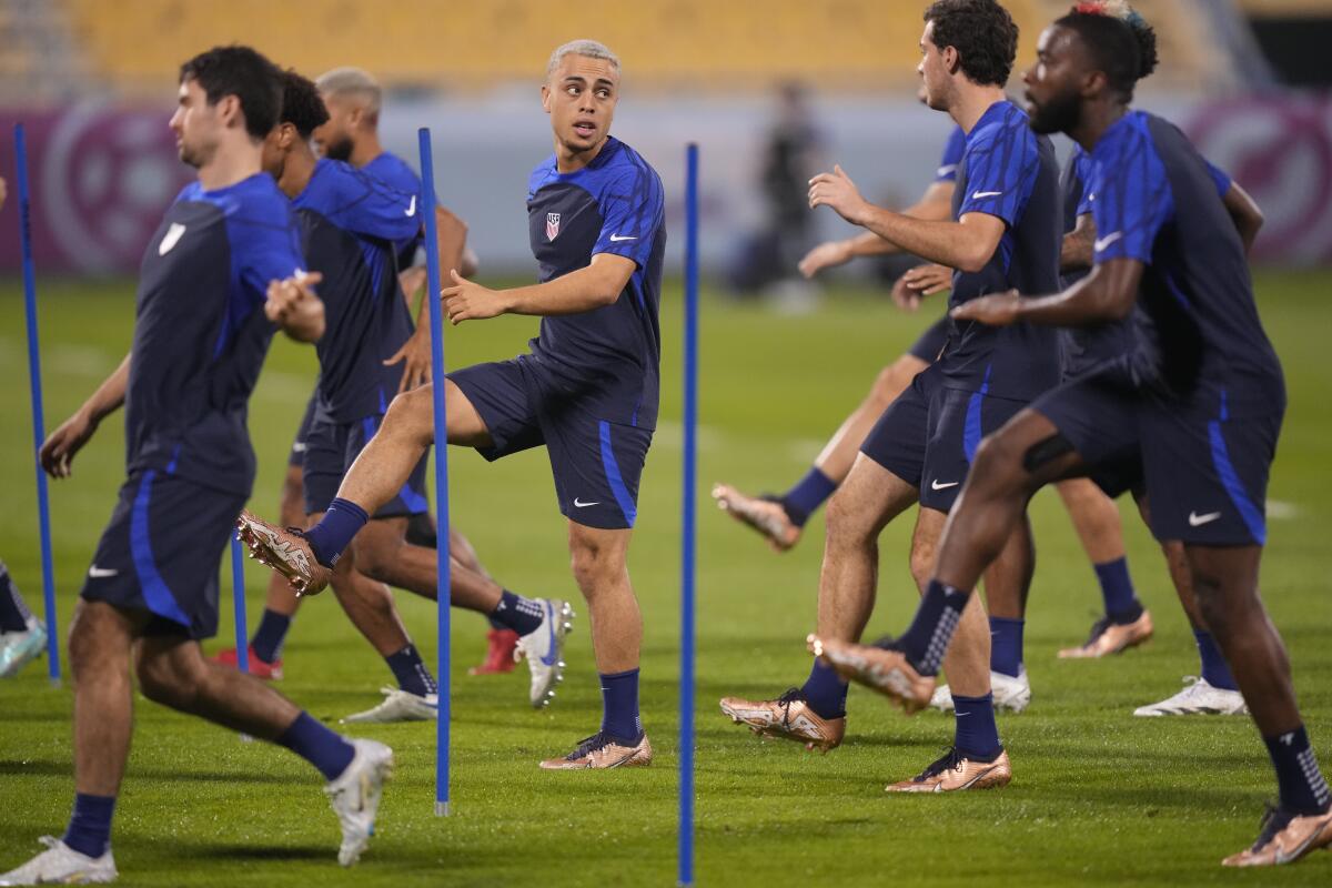 U.S. defender Sergi?o Dest, center, works out with his teammates during a training session Friday.