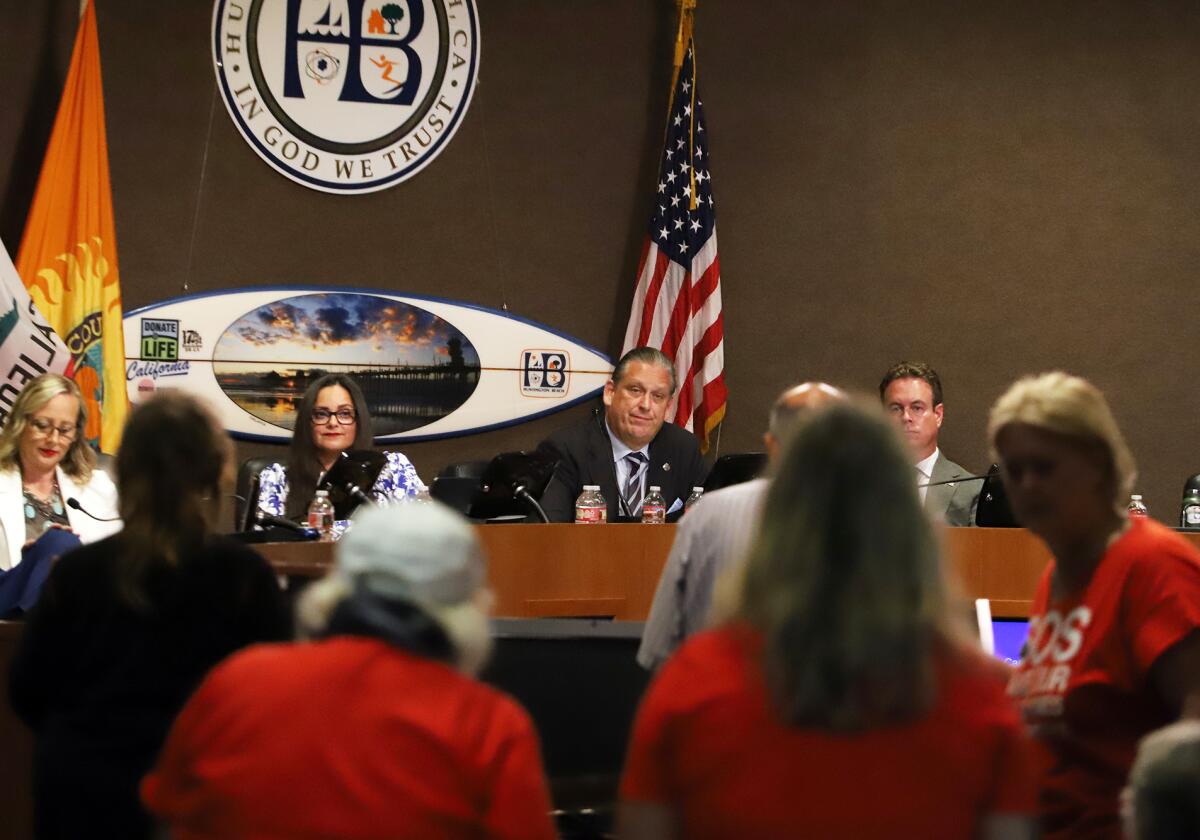 Huntington Beach Mayor Tony Strickland, center, and the City Council listen to concerned residents Tuesday night.