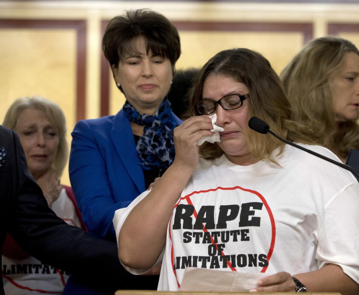 Norma Hernandez wipes her eyes as she talks during a news conference about being raped. Hernandez joined others in supporting SB 813, by Sen. Connie Leyva, center.