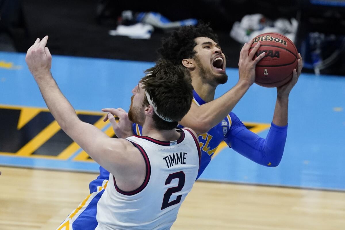 UCLA guard Johnny Juzang drives to the basket over Gonzaga forward Drew Timme during the second half.