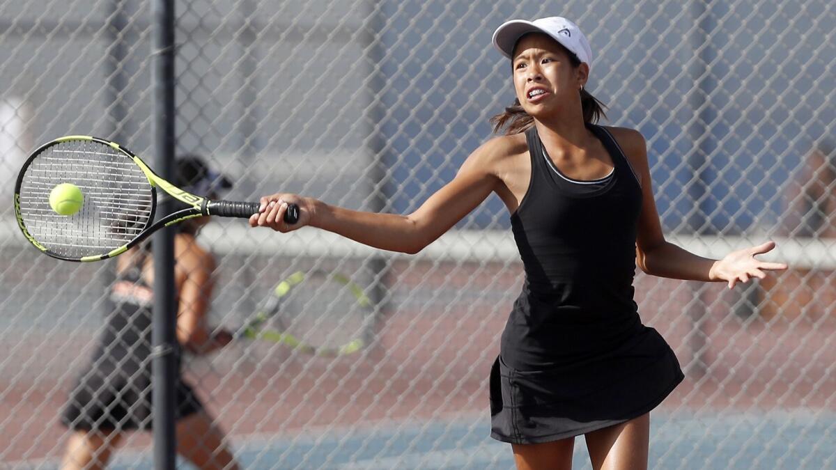 Cindy Huynh competes for Huntington Beach High during a No. 3 singles set of a Sunset Conference crossover match at Fountain Valley on Thursday.