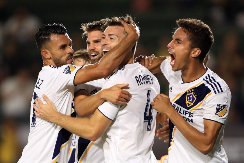 CARSON, CALIFORNIA - JULY 23: Dave Romney #4 is congratulated after scoring a goal by Ethan Zubak #29 , Efrain Alvarez #26 and Emil Cuello #27 during the second half of the quarterfinal match against Tijuana of the 2019 Leagues Cup at Dignity Health Sports Park on July 23, 2019 in Carson, California. (Photo by Sean M. Haffey/Getty Images)