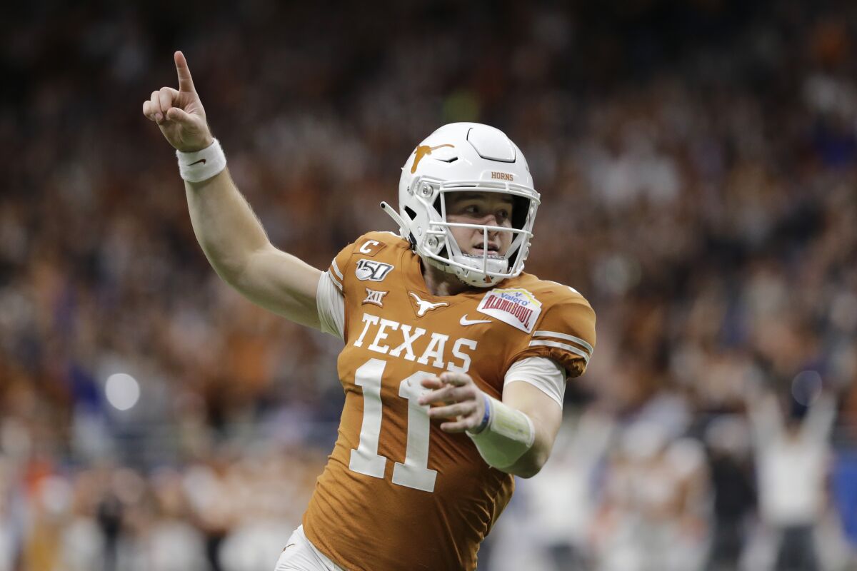 FILE - Texas quarterback Sam Ehlinger celebrates a touchdown against Utah during the first half of the Alamo Bowl NCAA college football game in San Antonio, Tuesday, Dec. 31, 2019. Ehlinger enters his fourth season as a starter and his 8,870 yards and 68 touchdowns both rank second in program career passing records. (AP Photo/Austin Gay, FIle)