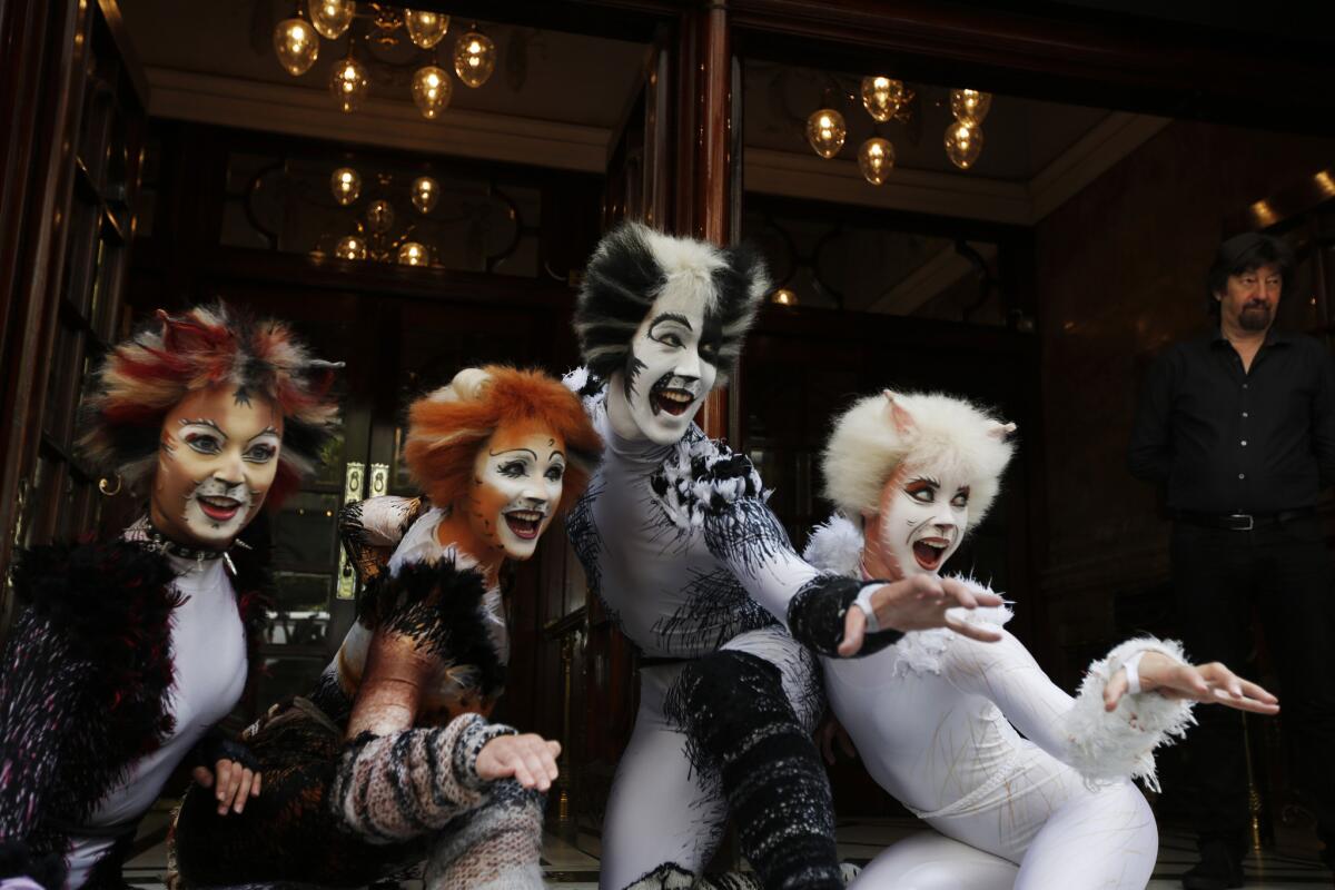 Performers in "Cats" costumes pose during a photo-op to promote the return of British composer Andrew Lloyd Webber's popular musical to London in December.