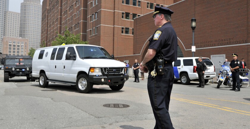 A U.S. marshal's van, believed to be carrying Boston Marathon bombing suspect Dzhokhar Tsarnaev, arrives at the federal courthouse in Boston for his arraignment.