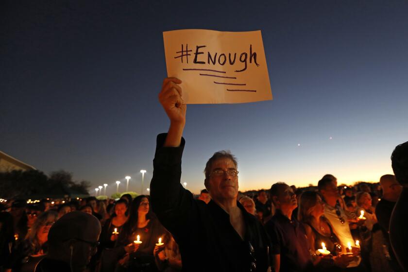 Thousands gather for a vigil at Pine Trails Park in Parkland, Fla., to remember those who were killed and injured in the shooting.