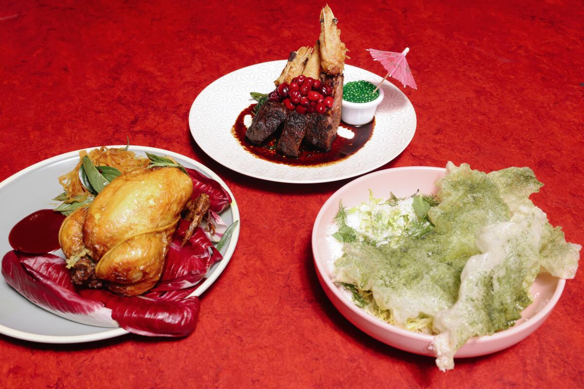 Dishes of game hen, the surf and turf and Thai Caesar salad arranged on a table