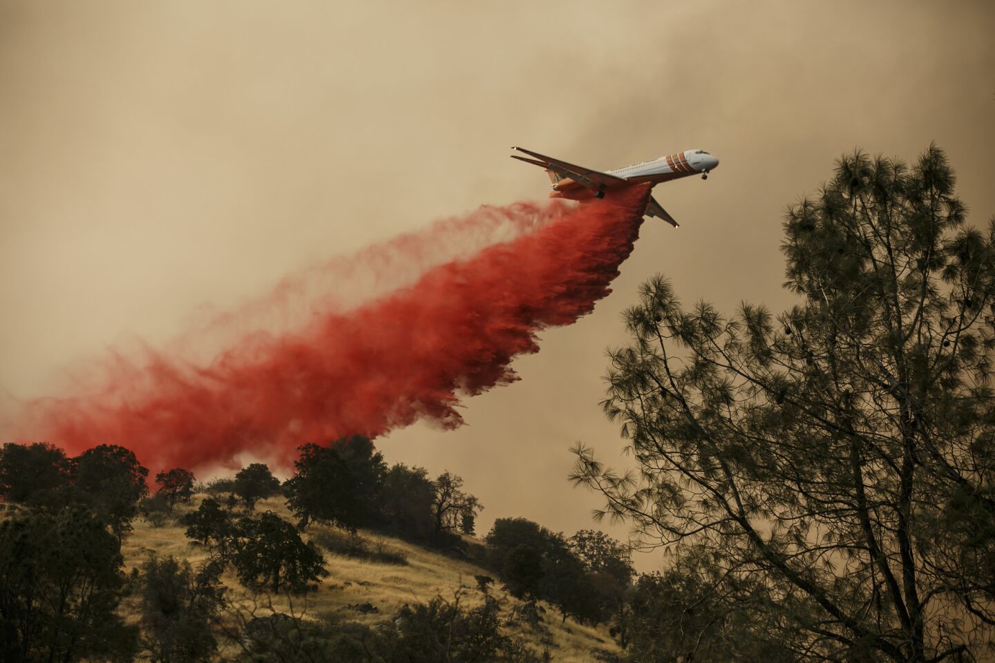 Fire retardant is dropped on a side of a hill near Mariposa, Calif.