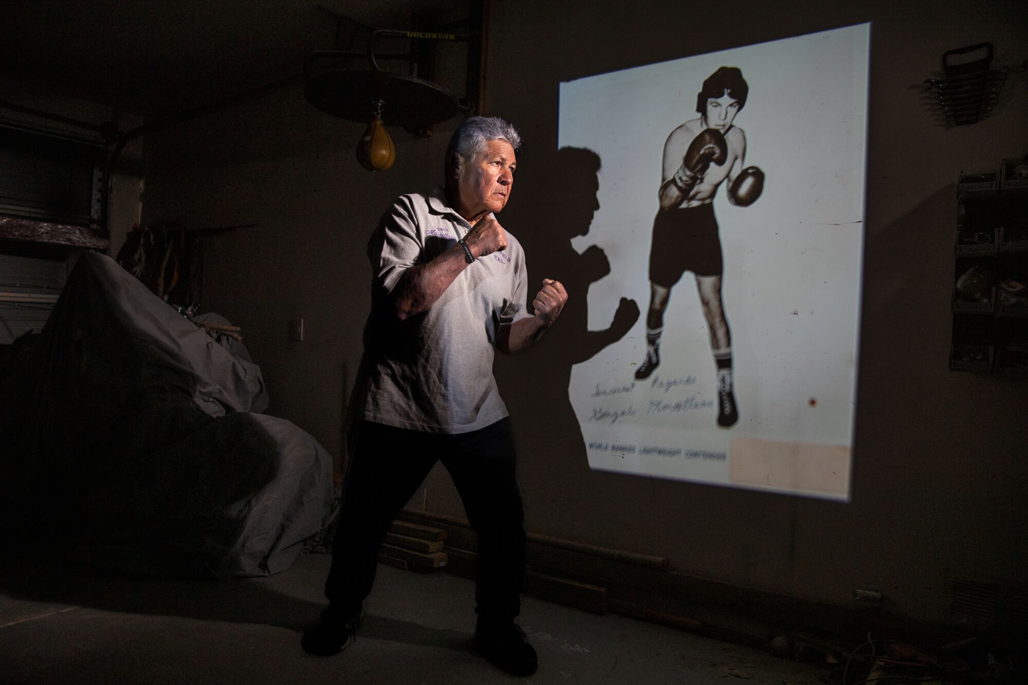  Gonzalo Montellano is shown shadow boxing in front of a boxing photo.