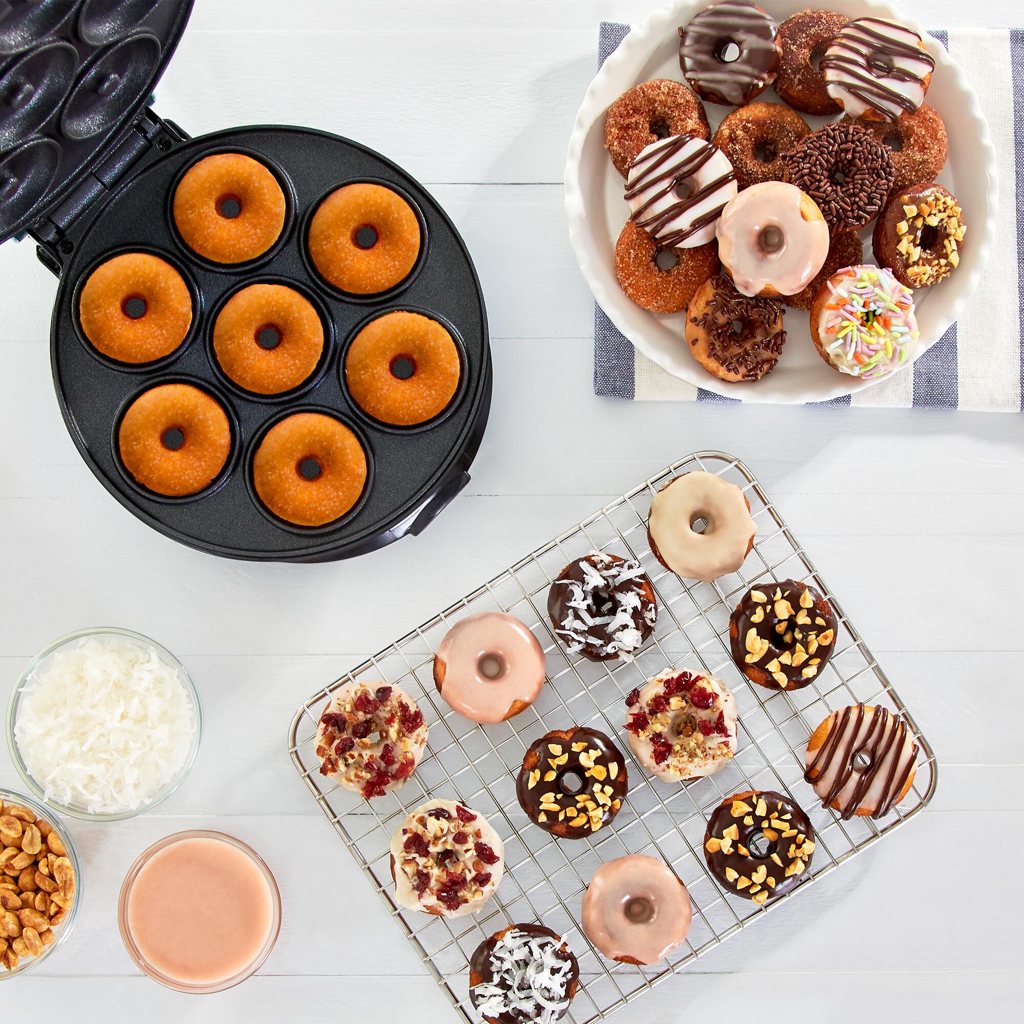 Dash Express Mini Donut Maker with an assortment of mini doughnuts