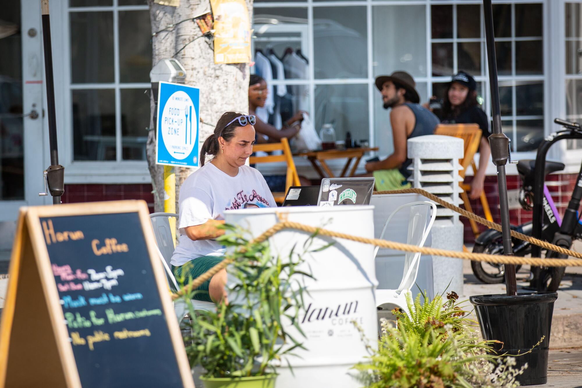 A women works outdoors at Harun Coffee in Leimert Park.