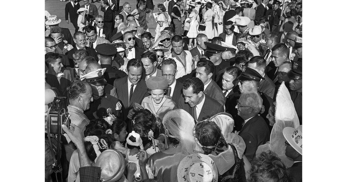Vice President Richard Nixon and his wife, Pat, are hemmed in by more than 3,000 well-wishers after leaving LAX.