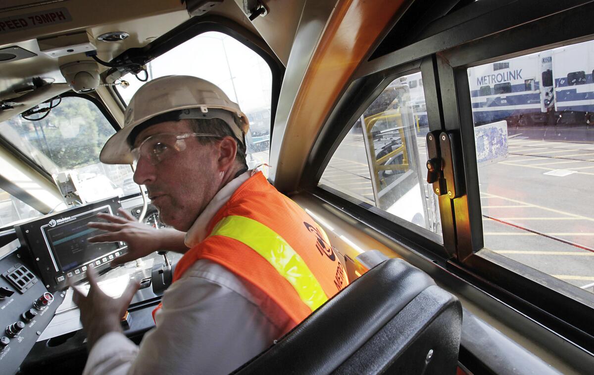 Neil Brown, a mechanical systems manager with Metrolink, explains in 2012 the workings of positive train control technology installed aboard a commuter train in Los Angeles.